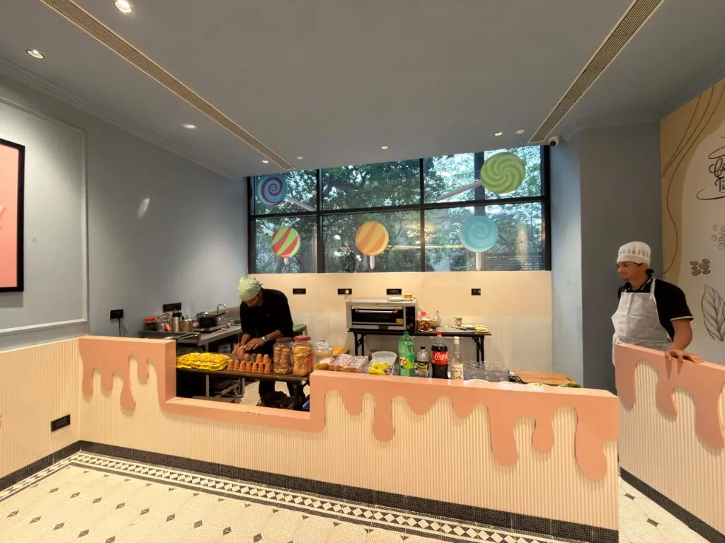 Staff at the counter - kulhads stacked, cookies in jars, the neighbourhood corner in motion